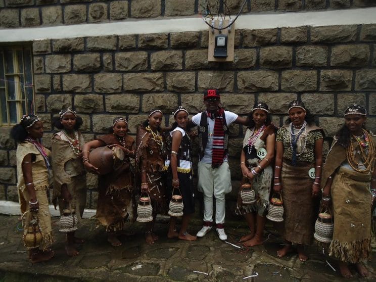 Hadiya Ethiopia: Women and a man. Women are wearing traditional clothing, hairdo, and beauty decorations. Seems that the man is in traditional clothing minus the hat, sunglasses, and the shoes Feb 2015